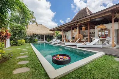 a villa with a swimming pool and a house at Renovated Villa Aksara Oberoi, 700m to Beach in Seminyak