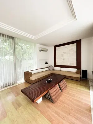 a living room with a couch and a table at The Wangsa Benoa in Nusa Dua