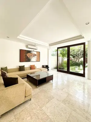 a living room with a couch and a table at The Wangsa Benoa in Nusa Dua