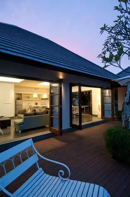 a house with a swimming pool and a patio at Nunia Boutique Villa in Seminyak