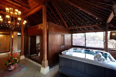 a large bathroom with a large tub in a building at Putu Bali Villa & Spa in Seminyak