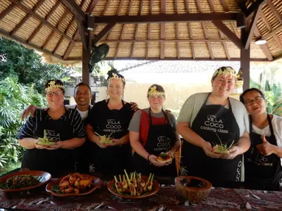 a group of people standing in front of a table with food at Villa Coco Bali in Seminyak