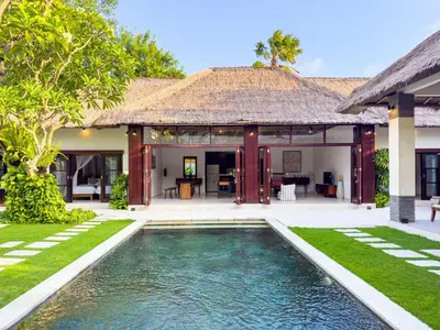 an exterior view of a villa with a swimming pool at Villa Bugis Seminyak in Seminyak
