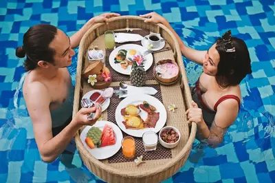 a group of people in a boat in a swimming pool at Lasanti Villas Seminyak in Seminyak