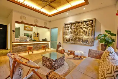 a living room with a couch and a table at Lasanti Villas Seminyak in Seminyak