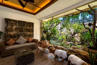 a living room with a couch and a large window at Lasanti Villas Seminyak in Seminyak