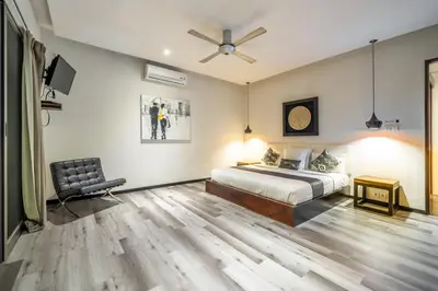 a bedroom with a bed and a ceiling fan at Villa Onyx in Seminyak