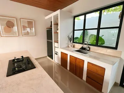 a kitchen with a sink and a window at Amerta Villa Seminyak in Seminyak