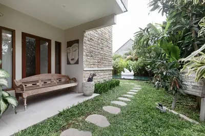a patio with a bench and some plants at Dasa Villa in Seminyak