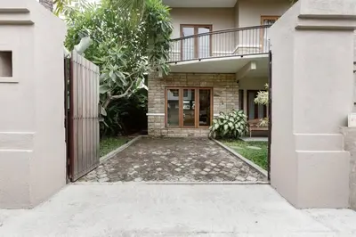 a house with a gate and a walkway in front at Dasa Villa in Seminyak