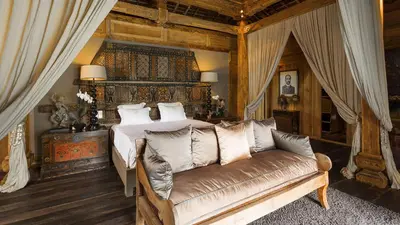 a bedroom with a bed and a couch at Villa Zelie in Canggu