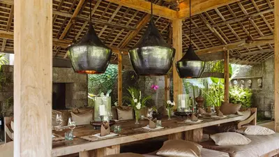 a dining room with a table in a resort at Villa Zelie in Canggu