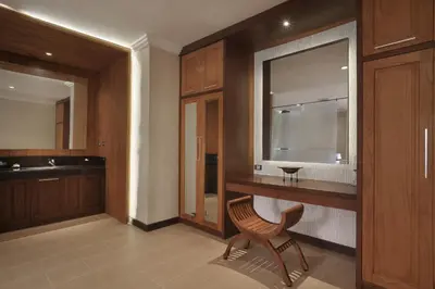 a bathroom with a wooden counter and a chair in it at Pelangi Bali Hotel & Spa in Seminyak