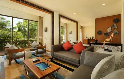 a living room with a couch and a table at The Seminyak Beach Resort & Spa in Seminyak