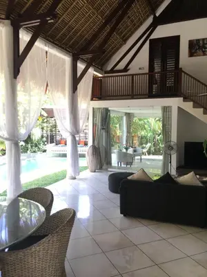 a living room with a couch and a table at Esha Villa Umalas 2 in Kerobokan