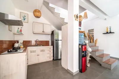 a kitchen with a sink and a refrigerator at Villa Wiana by Villa Finder in Seminyak