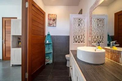 a bathroom with a sink and a toilet at Villa Wiana by Villa Finder in Seminyak