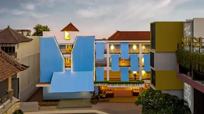 a view of a building with blue doors at Kampi Hotel Legian in Legian
