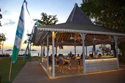 people sitting in a gazebo on the beach at Bali Garden Beach Resort in Kuta
