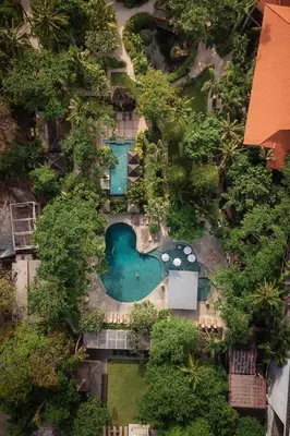 an overhead view of a swimming pool with trees at Bali Garden Beach Resort in Kuta