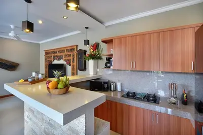 a kitchen with a bowl of fruit on a counter at Kae Villa Anggrek in Seminyak