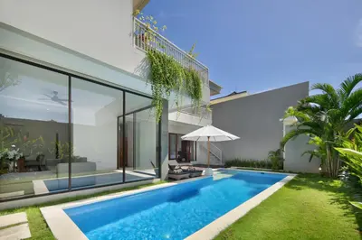 an external view of a villa with a swimming pool at Daha Mansions Seminyak in Seminyak