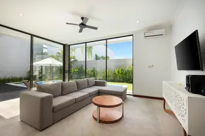 a living room with a couch and a tv at Daha Mansions Seminyak in Seminyak
