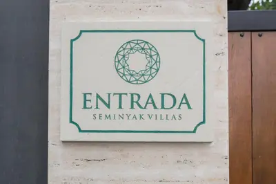 a sign for an emirada sign on a building at Entrada Seminyak Villa By Nagisa Bali in Seminyak