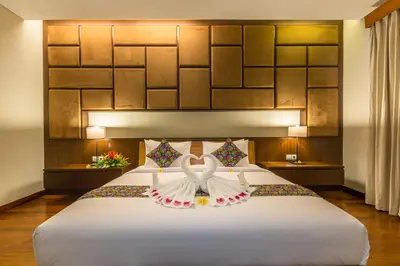 a bedroom with a large white bed with a dress on it at Entrada Seminyak Villa By Nagisa Bali in Seminyak