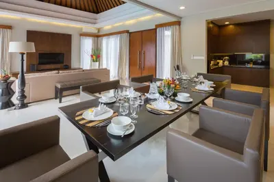 a dining room and living room with a table and chairs at Entrada Seminyak Villa By Nagisa Bali in Seminyak