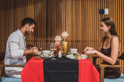 a man and a woman sitting at a table eating food at Sana Vie Villa Seminyak by Ini Vie Hospitality in Seminyak