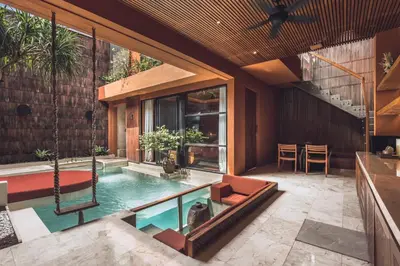 an indoor swimming pool in a house at Sana Vie Villa Seminyak by Ini Vie Hospitality in Seminyak