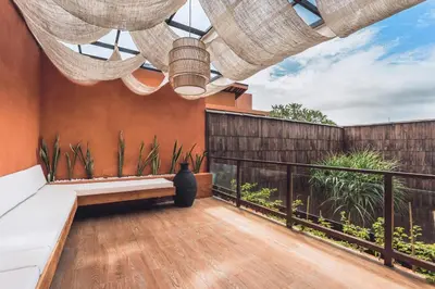 a balcony with a bench and a fence at Sana Vie Villa Seminyak by Ini Vie Hospitality in Seminyak