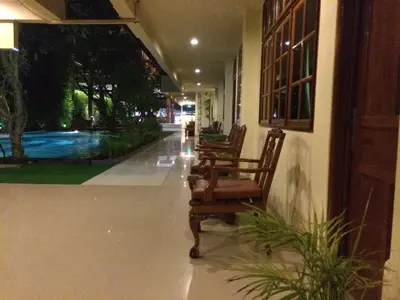 two chairs sitting in the hallway of a house at Green Garden Hotel in Kuta