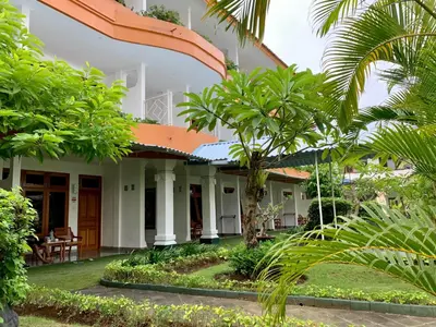 a house with trees in front of it at Febri's Hotel & Spa in Kuta