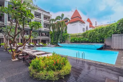 a resort with a swimming pool and a building at The Vira Bali Boutique Hotel & Suite in Kuta