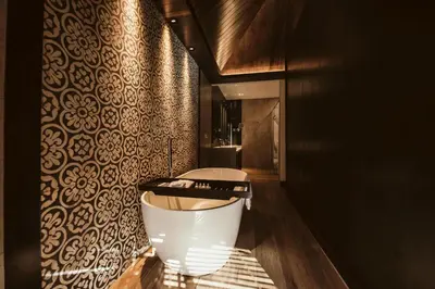 a bathroom with a bath tub in a room at The Vira Bali Boutique Hotel & Suite in Kuta