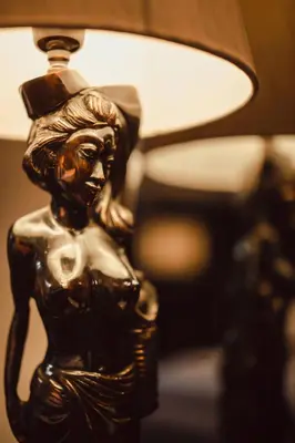 a bronze figurine of a woman with a lamp at The Vira Bali Boutique Hotel & Suite in Kuta