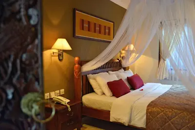 a bedroom with a bed with a canopy at Puri Dewa Bharata Hotel & Villas in Legian