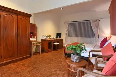 a hotel room with a bed and a living room at Puri Dewa Bharata Hotel & Villas in Legian