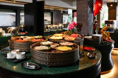 a buffet of food on a table in a restaurant at Rama Beach Resort and Villas in Kuta