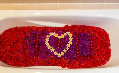 a tub filled with red and purple beads with a heart at Champlung Mas Hotel Legian in Legian