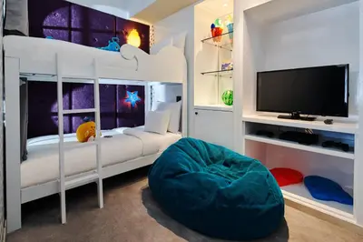 a bedroom with a bunk bed with a flat screen tv at Hard Rock Hotel Bali in Kuta