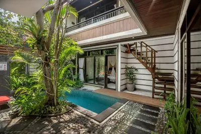 a house with a swimming pool next to a house at The Bali Dream Villa Seminyak in Seminyak