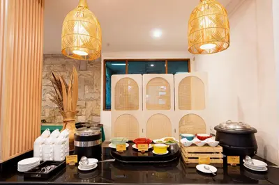 a kitchen with a table with food on it at Wina Holiday Villa Kuta Bali in Kuta