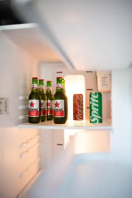 a refrigerator filled with bottles of coke and cans of soda at C151 Smart Villas at Seminyak in Seminyak