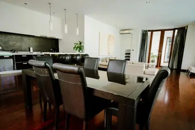 a dining room with a long table and chairs at C151 Smart Villas at Seminyak in Seminyak