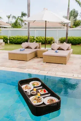 a tray of food is sitting in a pool at C151 Smart Villas at Seminyak in Seminyak