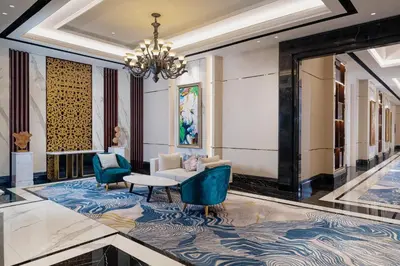 a lobby with a chandelier and a couch and chairs at InterContinental Bali Resort by IHG in Jimbaran