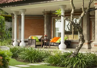 a porch with columns and a table and chairs at Holiday Inn Resort Baruna Bali by IHG in Kuta